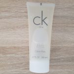 A tube of ck cream sitting on a wooden table.