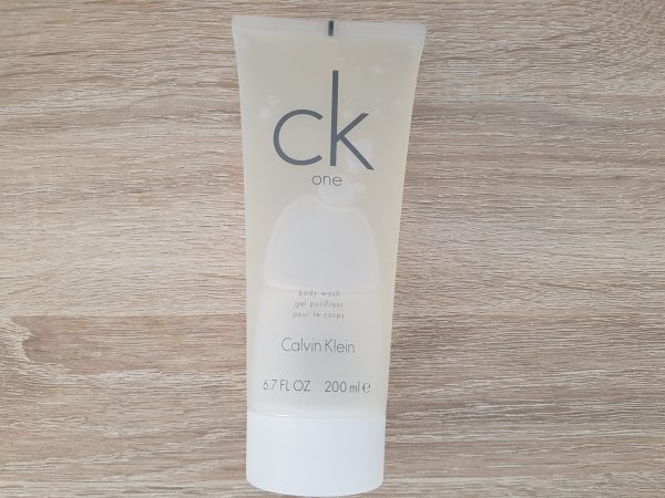 A tube of calvin klein cleanser on a wooden table.