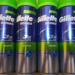 Four cans of gillette 3 series on a wooden table.