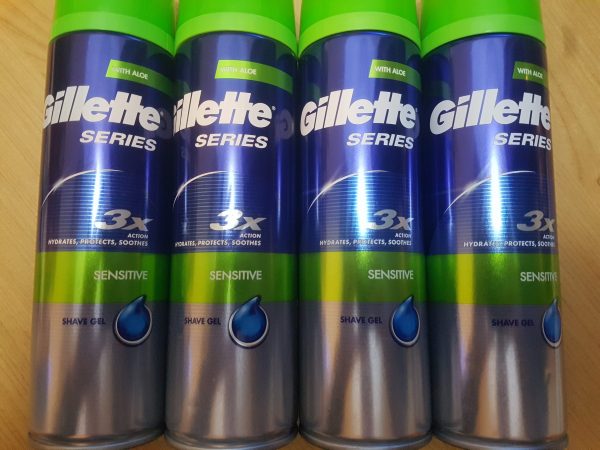 Four cans of gillette 3 series on a wooden table.