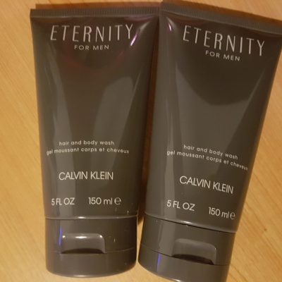 Two tubes of calvin klein eternity face wash on a wooden table.