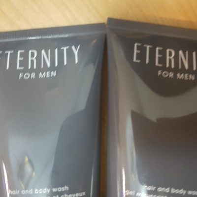 Two tubes of eternity for men on a wooden table.