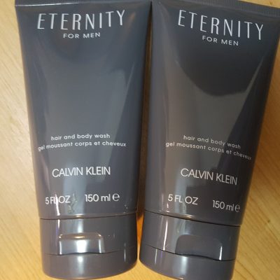 Two tubes of eternity for men on a wooden table.