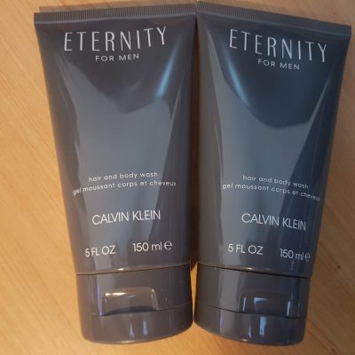 Two tubes of eternity for men on a wooden table.