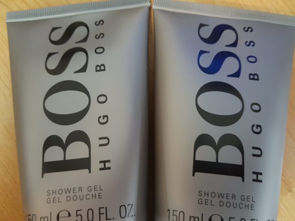 Two bottles of hugo boss shower gel on a table.