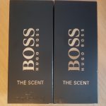 Two bottles of boss the scent on a table.