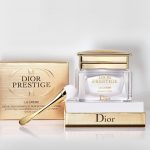 Dior Prestige La Creme Exceptional Regenerating & Perfecting Creme with a gold box and a spoon.