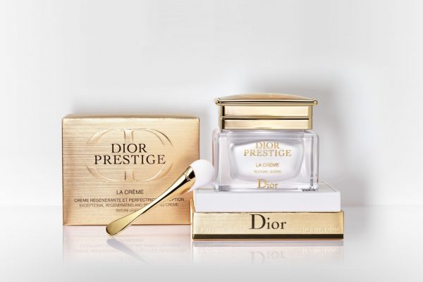 Dior Prestige La Creme Exceptional Regenerating & Perfecting Creme with a gold box and a spoon.