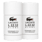 Two Lacoste L.12.12 Blanc Pure Deodorant Sticks for Men, in white with black crocodile logo and text on the front, stand upright side by side.