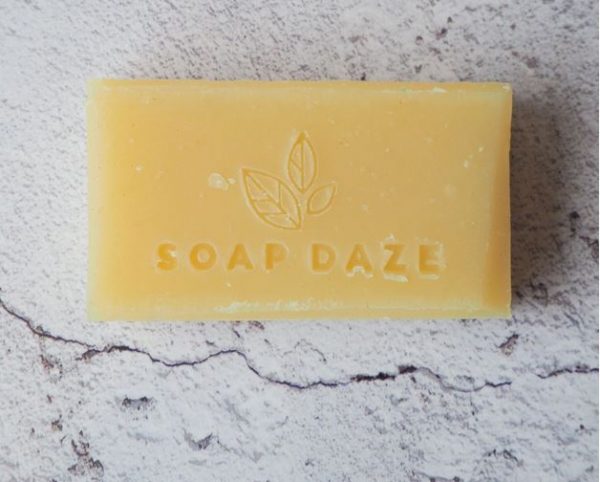 A bar of 3x Lemongrass & Patchouli Handmade Vegan Soap with the words 'soap daze' on it.