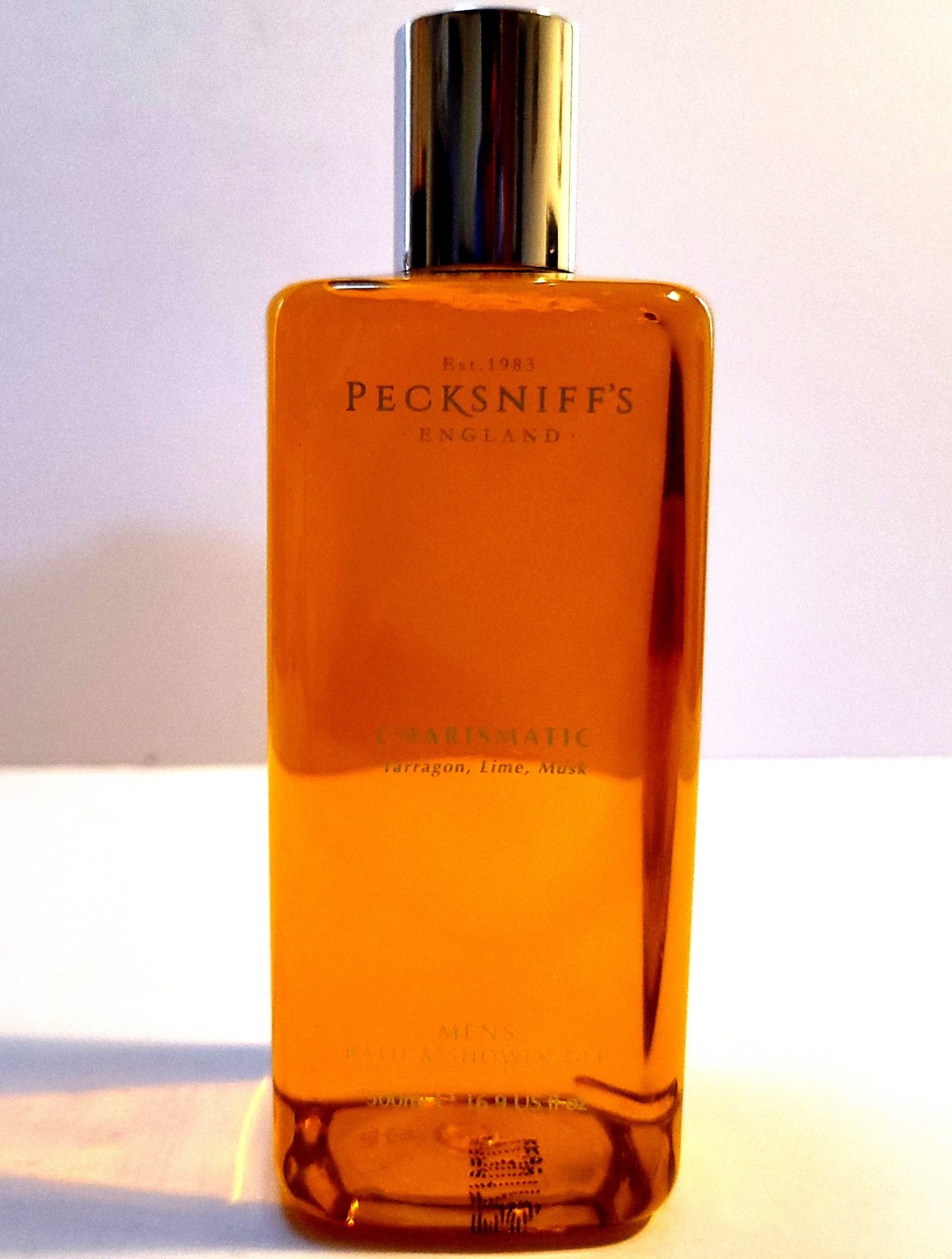 A bottle of Pecksniffs Charismatic Mens Bath & Shower Gel, 500ml on a white surface.