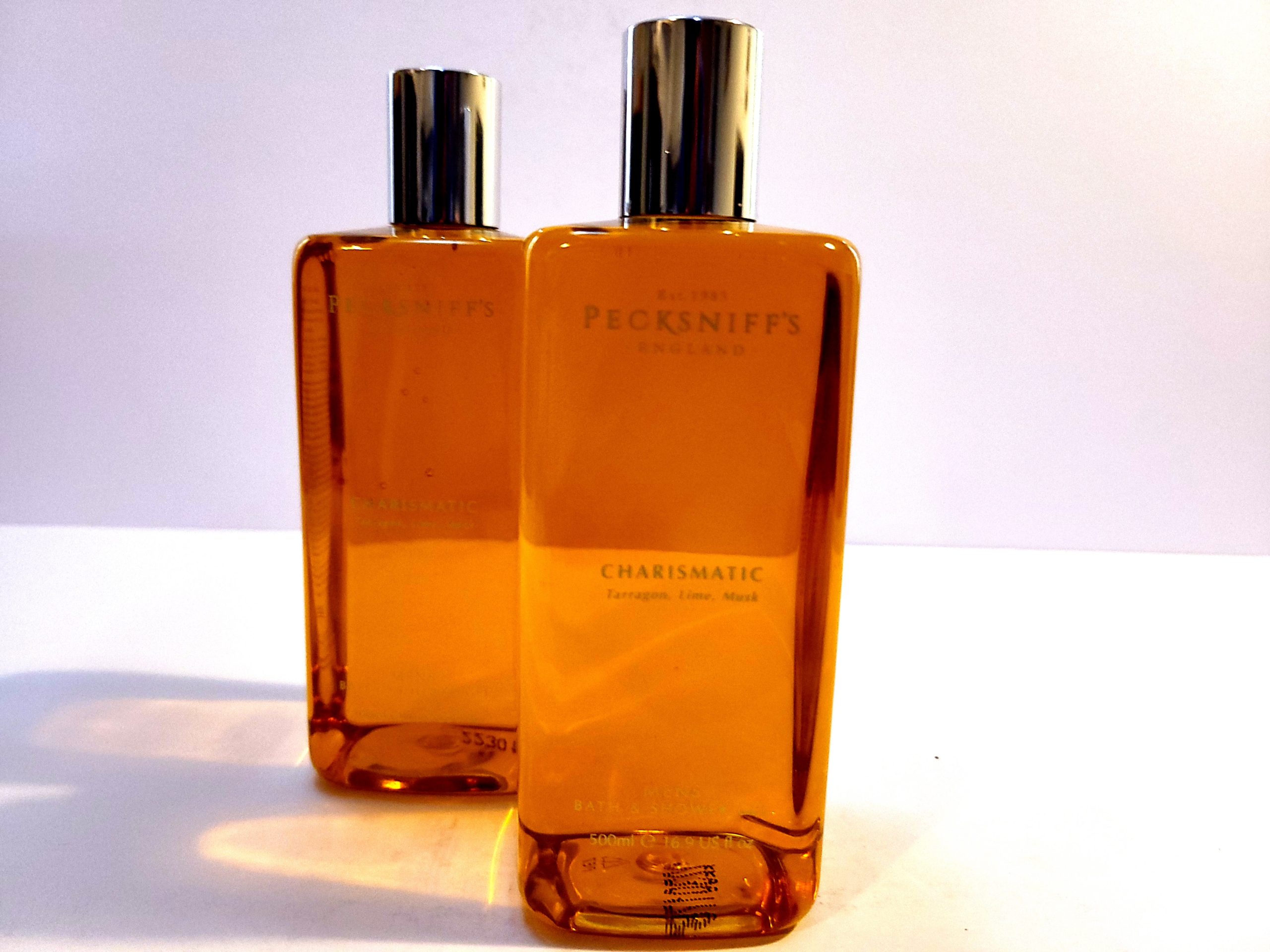 Two bottles of Pecksniffs Charismatic Mens Bath & Shower Gel, 500ml sitting on a white surface.