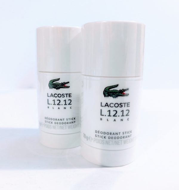 Two Lacoste L.12.12 Blanc Pure Deodorant Stick for Men on a white surface.