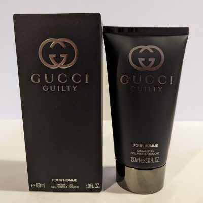 A tube of Gucci Guilty 150ml Shower Gel Body Wash for Men next to a box.