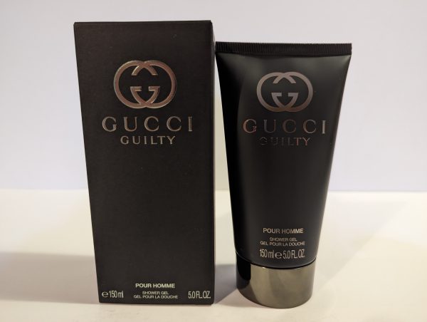 A tube of Gucci Guilty 150ml Shower Gel Body Wash for Men next to a box.