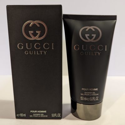 A tube of Gucci Guilty 150ml Shower Gel Body Wash for Men next to a box.