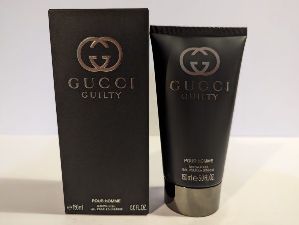 A tube of Gucci Guilty 150ml Shower Gel Body Wash for Men next to a box.