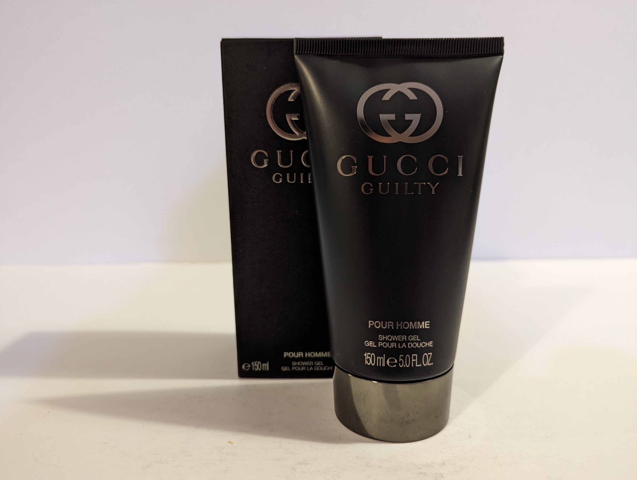 A tube of Gucci Guilty 150ml Shower Gel Body Wash for Men on a white background.