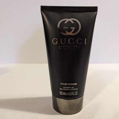 A tube of Gucci Guilty 150ml Shower Gel Body Wash for Men on a white surface.