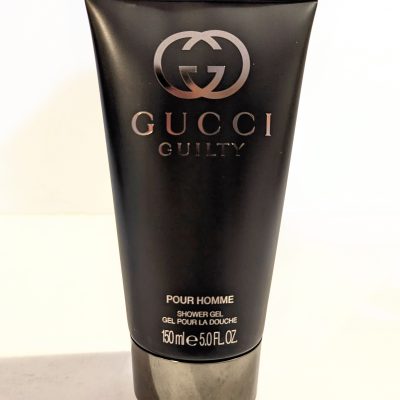 A tube of Gucci Guilty 150ml Shower Gel Body Wash for Men on a white surface.