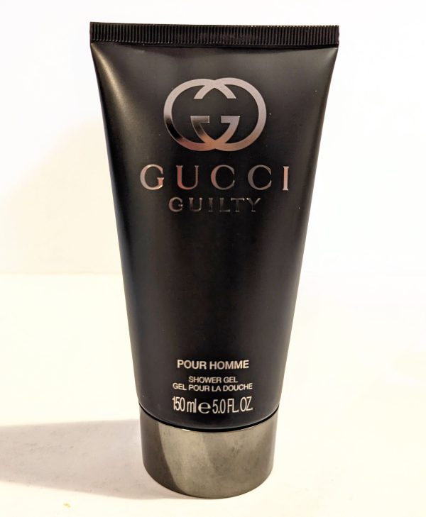 A tube of Gucci Guilty 150ml Shower Gel Body Wash for Men on a white surface.