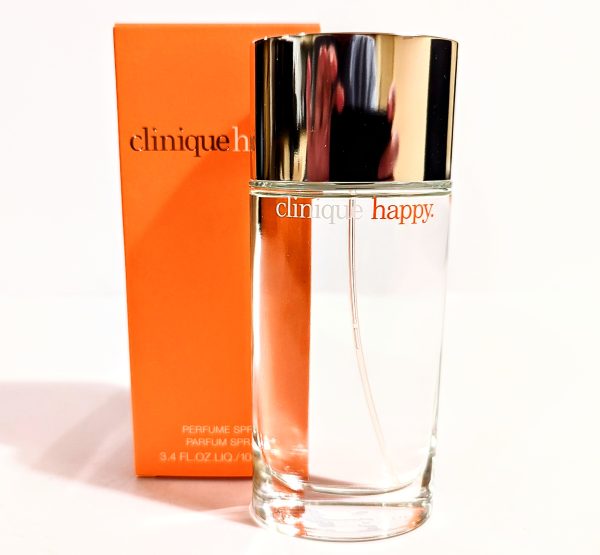 A bottle of Clinique Happy edp in front of a box.