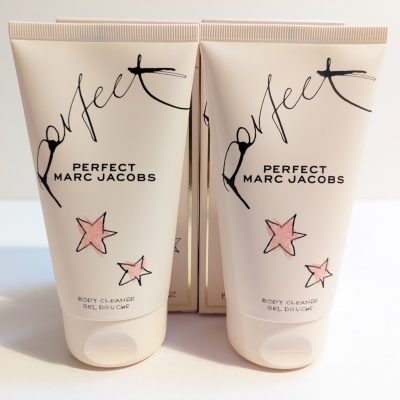 Two tubes of marc jacobs perfect body cleanse gel on a plain background.