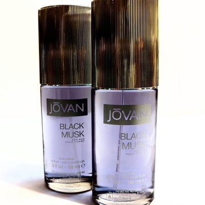 Two bottles of jovan black musk cologne against a white background.