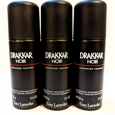 Three bottles of drakkar noir deodorant on a white surface.