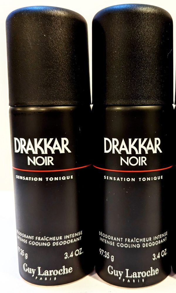 Three bottles of drakkar noir deodorant on a white surface.