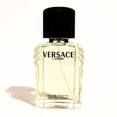 A bottle of versace cologne on a white background.