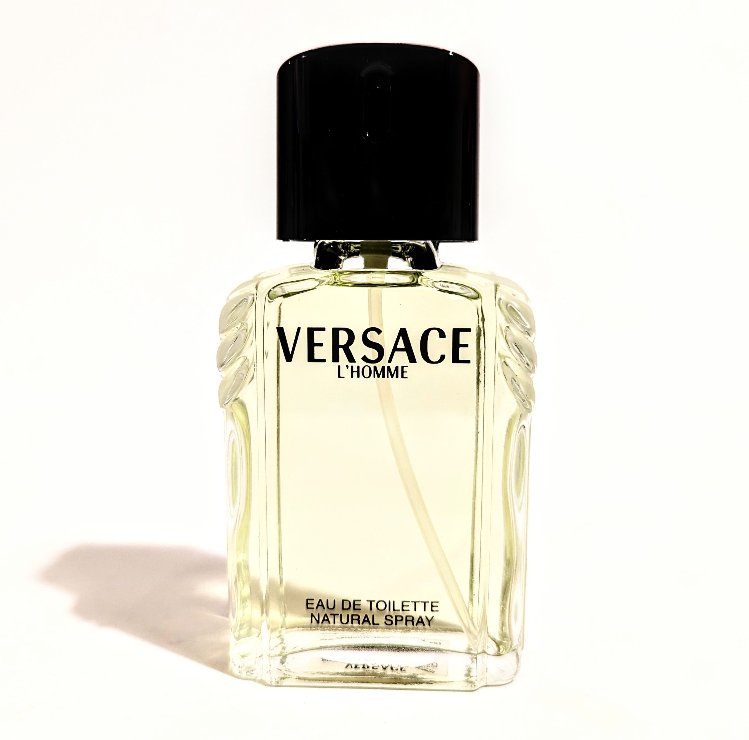 A bottle of versace cologne on a white background.