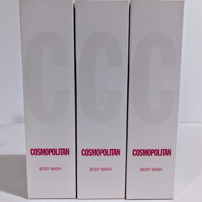 Three boxes of Cosmopolitan Body Wash are shown standing upright, each with white packaging and the brand name in red at the bottom.