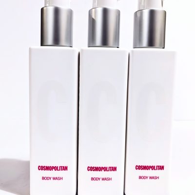 Three white bottles of Cosmopolitan Body Wash with pump dispensers, arranged side by side against a white background.