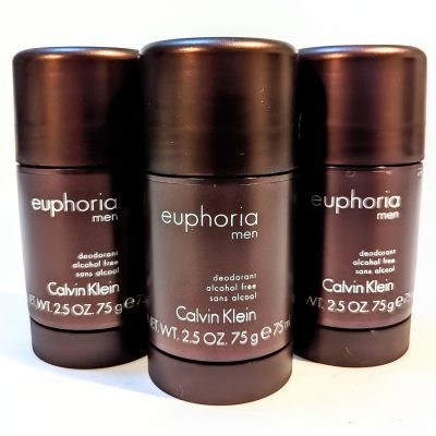 Three brown containers of Calvin Klein's Euphoria Men deodorant are displayed. Each is labeled as alcohol-free and weighs 2.5 oz (75 g).