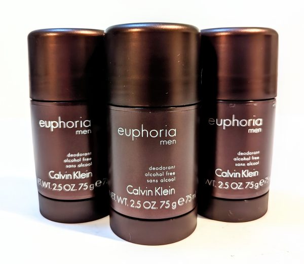 Three brown containers of Calvin Klein's Euphoria Men deodorant are displayed. Each is labeled as alcohol-free and weighs 2.5 oz (75 g).