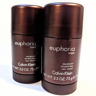 Two brown stick deodorants with the label "Euphoria Men" by Calvin Klein are displayed side by side. Each is 2.5 oz (75 g) and marked as alcohol-free.