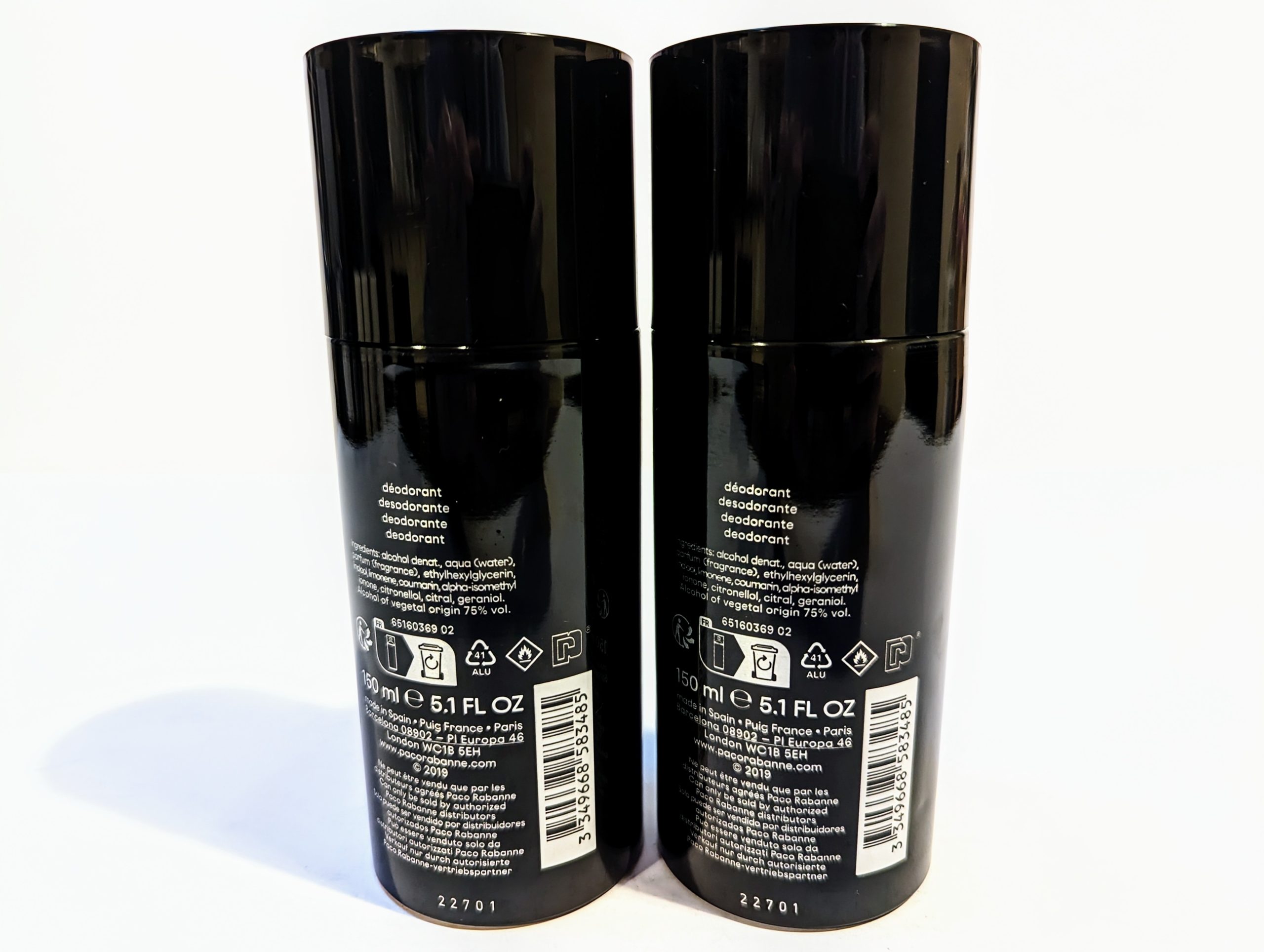 Two black deodorant spray cans facing backwards, displaying product labels and ingredient lists. Each can contains 150 ml (5.1 fl oz) of deodorant.