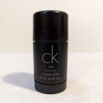 A black, cylindrical deodorant stick with "ck be" written on it in light gray text. The label indicates it is a Calvin Klein product with a net weight of 2.6 ounces (75 grams).