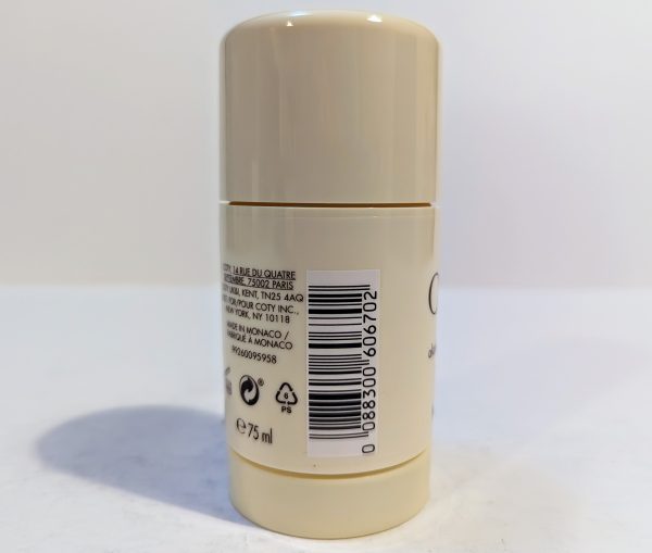 A cylindrical beige deodorant stick showing its barcode, recycling symbols, and text with usage information on the back label.