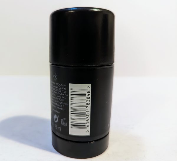 Black cylindrical deodorant container with a label, bar code, and text indicating ingredients and details.