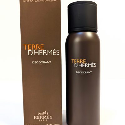 Image of Terre D’Hermes deodorant spray bottle next to its box. The bottle and box are brown with text indicating 150 ml or 5 fl.oz.