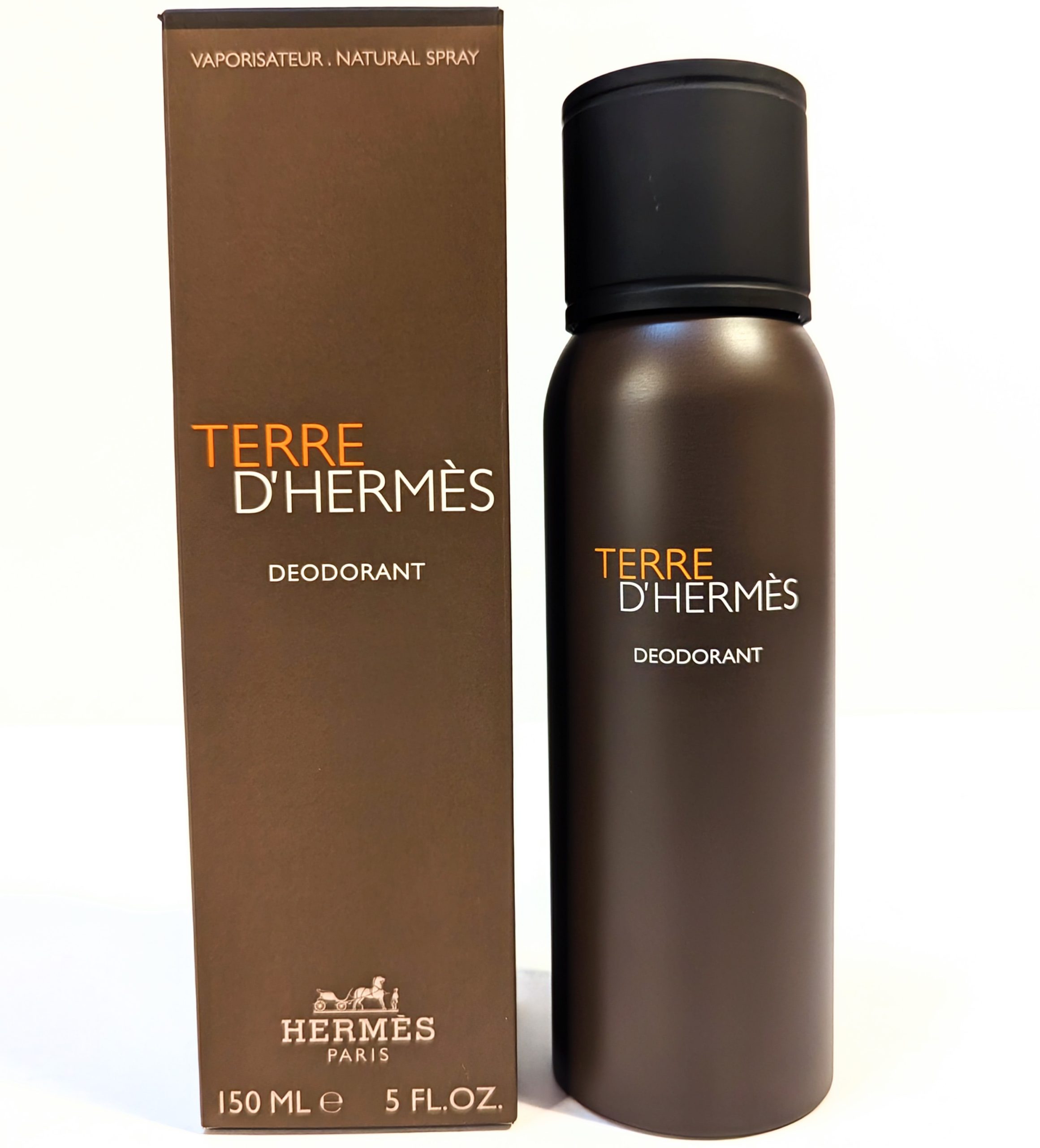 Image of Terre D’Hermes deodorant spray bottle next to its box. The bottle and box are brown with text indicating 150 ml or 5 fl.oz.