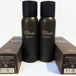 Two black bottles of Hermès Terre d'Hermès deodorant are placed upright between their boxes. The text on the bottles and boxes describes the product details.