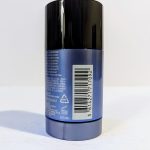 A cylindrical blue deodorant stick with a black cap is shown. The back label contains ingredients, a barcode, and a recycling symbol.