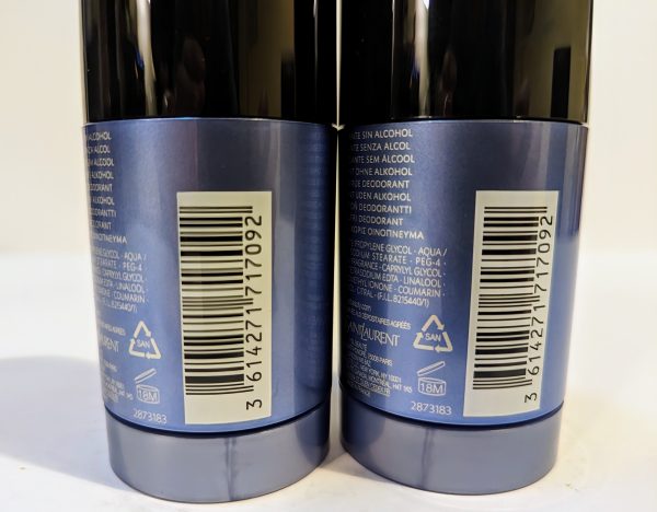 Two deodorant containers are placed side by side, showing labels with product information, barcodes, and ingredients listed in multiple languages.