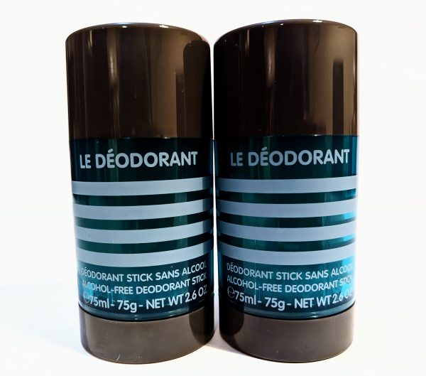 Two black cylindrical containers of "Le Déodorant," labeled as alcohol-free deodorant sticks, each containing 75 ml (2.6 oz) of product.