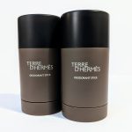 Two bottles of Terre d'Hermès deodorant sticks with brown containers and black caps stand side by side on a white background.