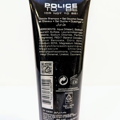 A black bottle of "Police To Be" shower gel with ingredients listed on the back label in multiple languages, a QR code, and recycling instructions.