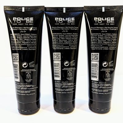 Three tubes of Police To Be shower gel are displayed side by side. The black labeled tubes show the product name, ingredients, recycling information, and the 12-month usage period after opening.